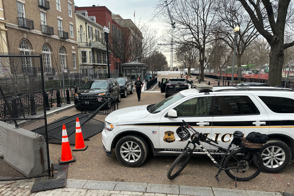 Washington Metropolitan Police Department officers block the streets around the White House as members of the U.S. Secret Service investigate a suspicious vehicle, Wednesday, March 11, 2026, in Washington. (AP Photo/Nathan Ellgren)