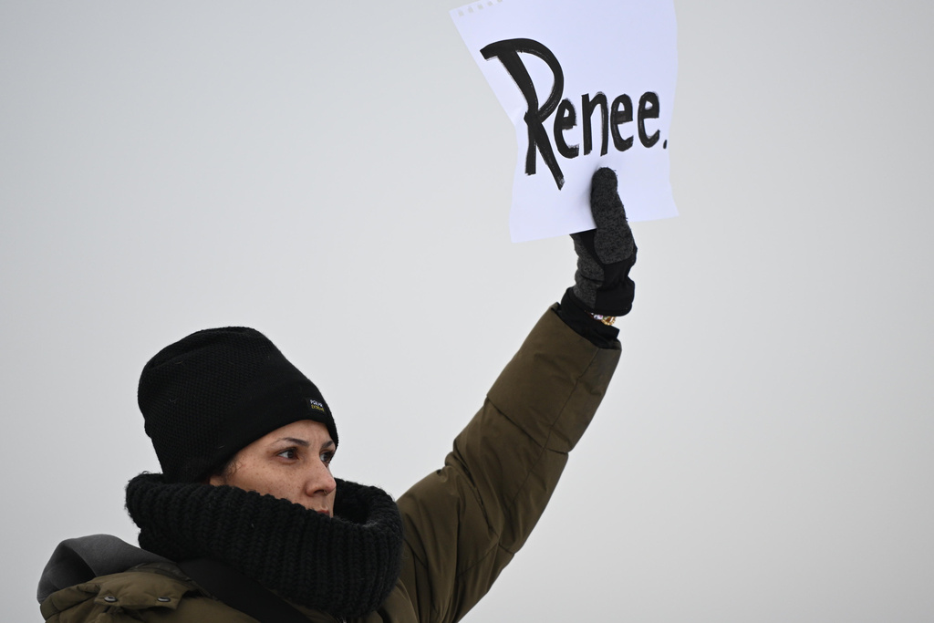 A protesters holds up a sign reading "Renee", the woman shot and killed by a U.S. Immigration and Customs Enforcement officer in Minneapolis on Wednesday, outside the Bishop Henry Whipple Federal Building, Thursday, Jan. 8, 2026, in Minneapolis, Minn. (AP Photo/Tom Baker)