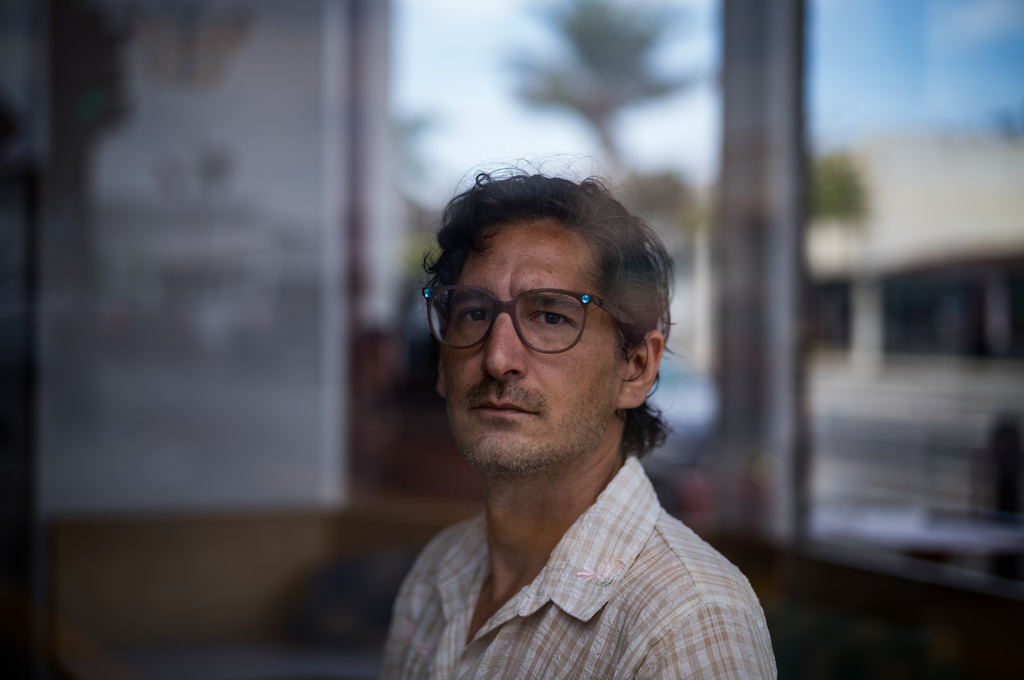 Jonathan Caravello, a lecturer at California State University Channel Islands, sits for a photo in Ventura, Calif., Friday, Aug. 28, 2026. (AP Photo/Jae C. Hong)