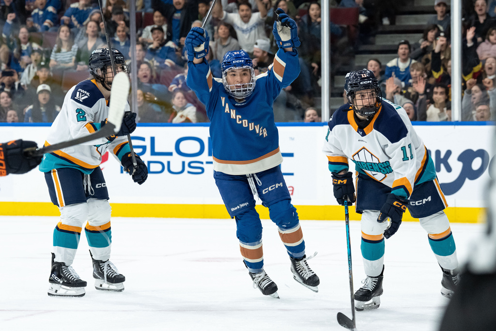 Vancouver Goldeneyes' Anna Segedi (51) celebrates her goal as New York Sirens' Nicole Vallario (11) watches the goal during the first period of a PWHL hockey game in Vancouver, on Wednesday, March 18, 2026. (Ethan Cairns/The Canadian Press via AP)