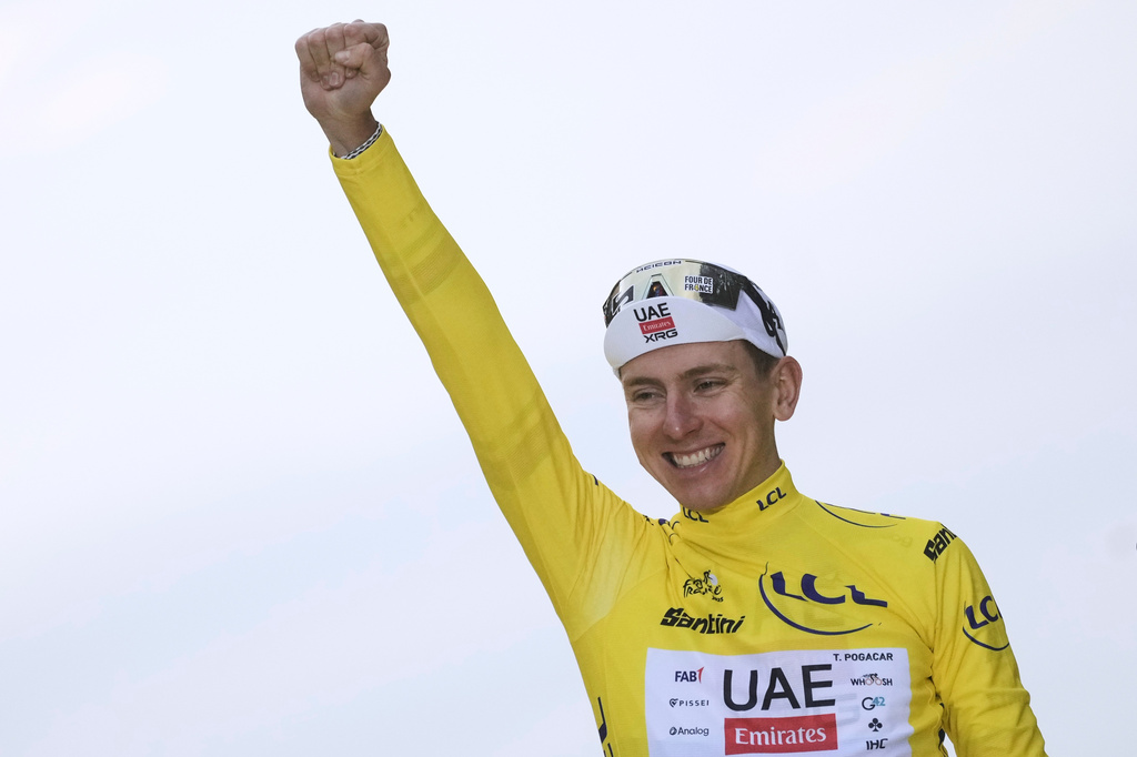 FILE - Tour de France winner Tadej Pogacar of Slovenia celebrates on the podium after the twenty-first stage of the Tour de France cycling race over 132.3 kilometers (82.1 miles) with start in Mantes-la-Ville and finish on the Champs-Elysees in Paris, France, on July 27, 2025. (AP Photo/Thibault Camus, File)