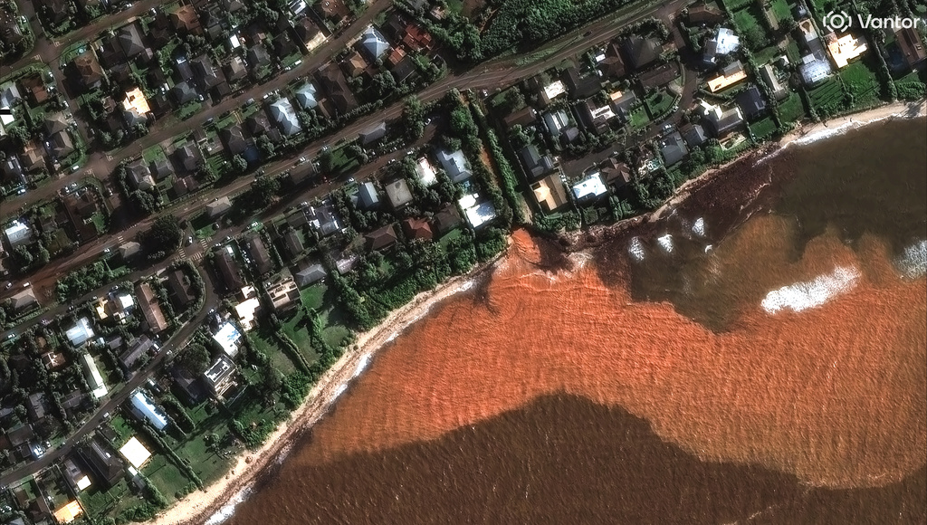 This satellite image provided by Vantor shows storm sediment and mud going into the ocean after heavy rains, Monday, March 23, 2026, in neighborhoods near Waialua, Hawaii. (Satellite image ©2026 Vantor via AP)