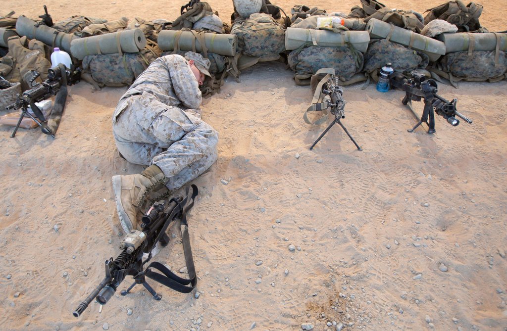 FILE - U.S. Marine Lcpl. Scott Rucker, of Tampa, Fla., takes a nap at the Marine Corps Air Ground Combat Center in Twentynine Palms, Calif., on Sept. 29, 2009. (AP Photo/Jae C. Hong, File)
