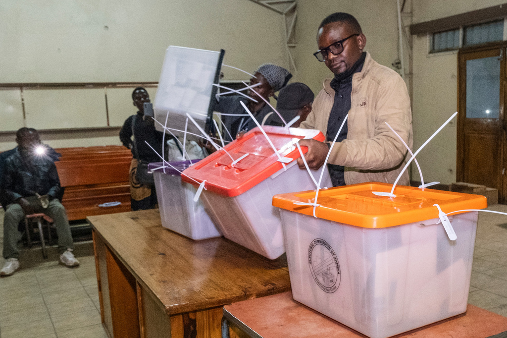 Election workers open containers of ballots as counting begins in Lusaka, Zambia, Thursday, Aug. 13, 2026. (AP Photo/Anita Reed)