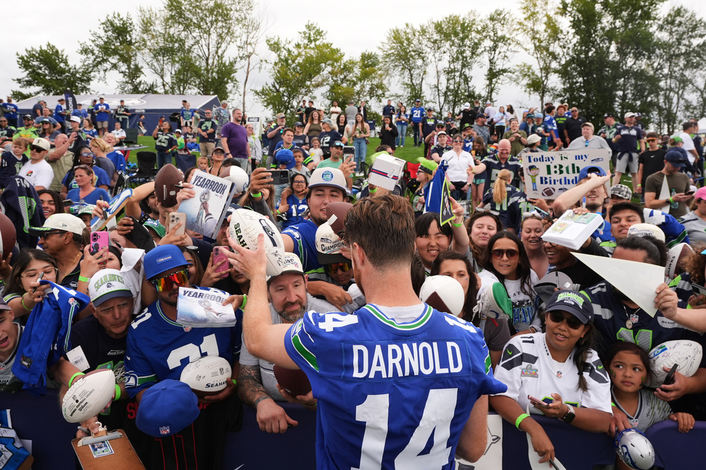 Seattle Seahawks quarterback Sam Darnold signs autographs during the NFL football team's training camp, Saturday, July 25, 2026, in Renton, Wash. (AP Photo/Lindsey Wasson)