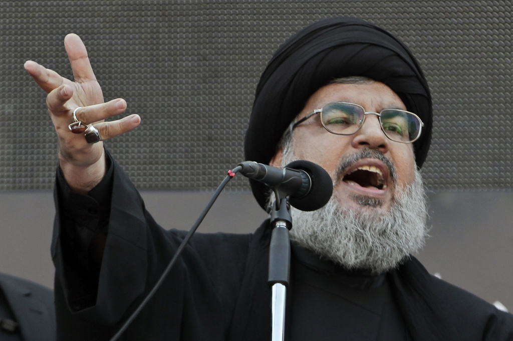 FILE - Hezbollah leader Sheik Hassan Nasrallah speaks to the crowd in a rare public appearance in the suburbs of Beirut on Nov. 14, 2013. (AP Photo/Bilal Hussein, File)