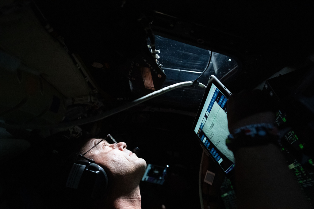 This image provided by NASA, astronaut and Artemis II Commander Reid Wiseman takes a moment during the seven-hour lunar observation period where the crew reported to the ground team their observations including color nuances, which will help enhance scientific understandings of the Moon on Monday, April 6, 2026. (NASA via AP)