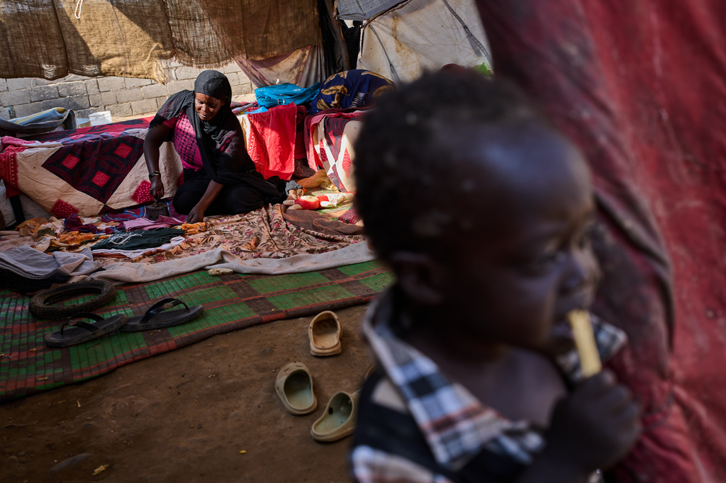 Internally displaced Sudanese Safia Abbakar irons inside her makeshift tent at the Al Heshan camp on the outskirts of Port Sudan, Sudan, Wednesday, April 15, 2026. (AP Photo/Bernat Armangue)