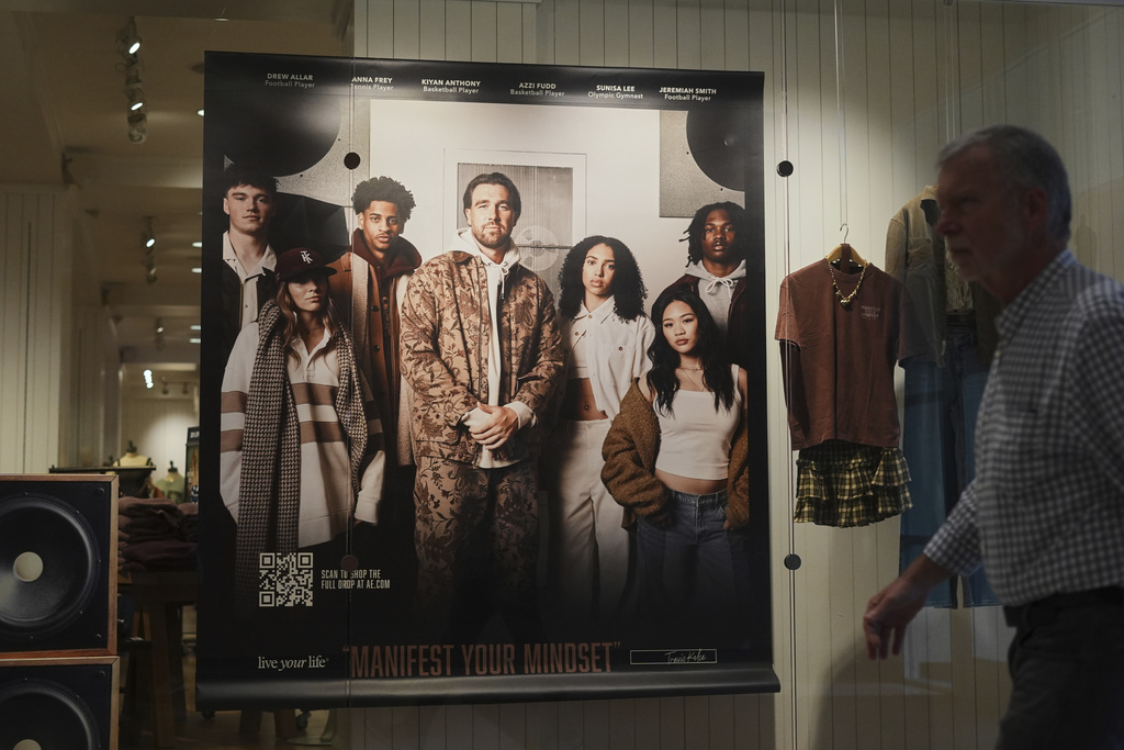 A shopper walks by an ad featuring Kansas City Chiefs' Travis Kelce outside an American Eagle Outfitters, Thursday, Sept. 4, 2025, in Bellevue, Wash. (AP Photo/Lindsey Wasson)