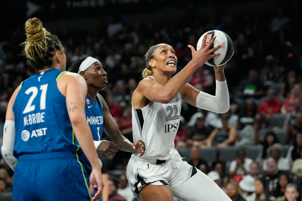 Las Vegas Aces center A'ja Wilson (22) shoots against Minnesota Lynx forward Natasha Howard (1) during the first half of a WNBA basketball game Saturday, June 13, 2026, in Las Vegas. (AP Photo/John Locher)