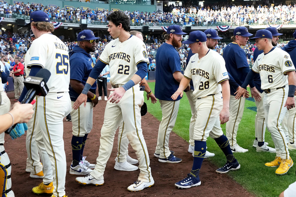 Milwaukee Brewers players high-five after defeating the Chicago Cubs 9-3 in Game 1 of baseball's National League Division Series, Saturday, Oct. 4, 2025, in Milwaukee. (AP Photo/Kayla Wolf)