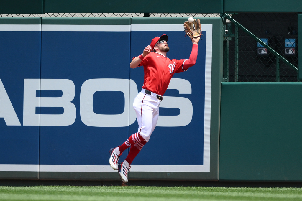 Washington Nationals right fielder Dylan Crews makes a leaping catch on a fly ball by Seattle Mariners' Julio Rodriguez for the out during the first inning of a baseball game, Sunday, June 14, 2026, in Washington. (AP Photo/Nick Wass)