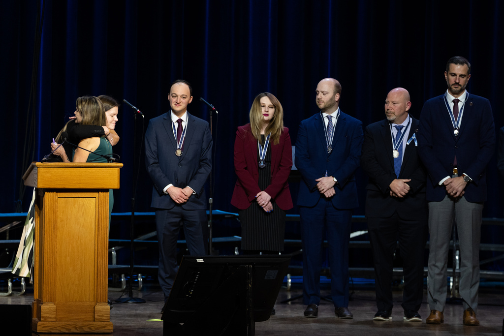 First responders accept medals at an event honoring the 67 lives lost in the 2025 midair collision near DCA airport, Wednesday, Jan. 28, 2026, in Washington. (AP Photo/Allison Robbert)