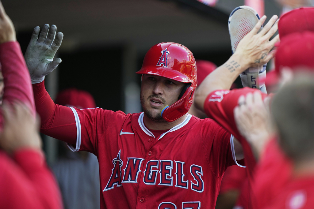 Los Angeles Angels designated hitter Mike Trout celebrates in the dugout after scoring off a double hit by Taylor Ward during the first inning of a baseball game against the Detroit Tigers, Saturday, Aug. 9, 2025, in Detroit. (AP Photo/Ryan Sun)