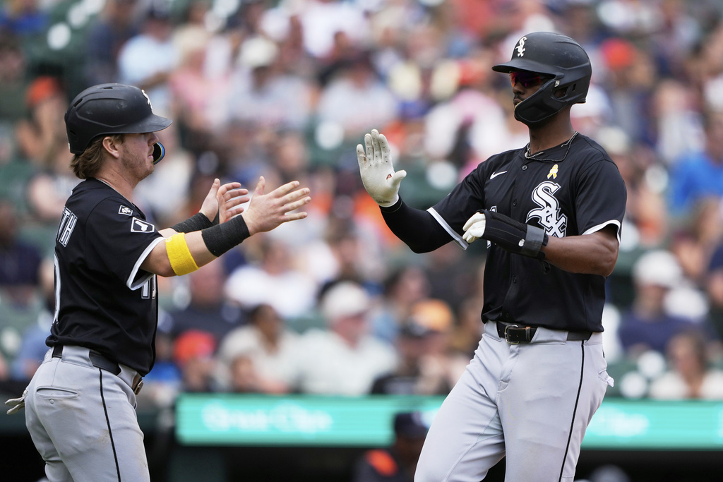 Chicago White Sox's Chase Meidroth, left, and Michael A. Taylor, right, celebrate after they scored off a single hit by Lenyn Sosa during the eighth inning of a baseball game against the Detroit Tigers, Sunday, Sept. 7, 2025, in Detroit. (AP Photo/Ryan Sun)