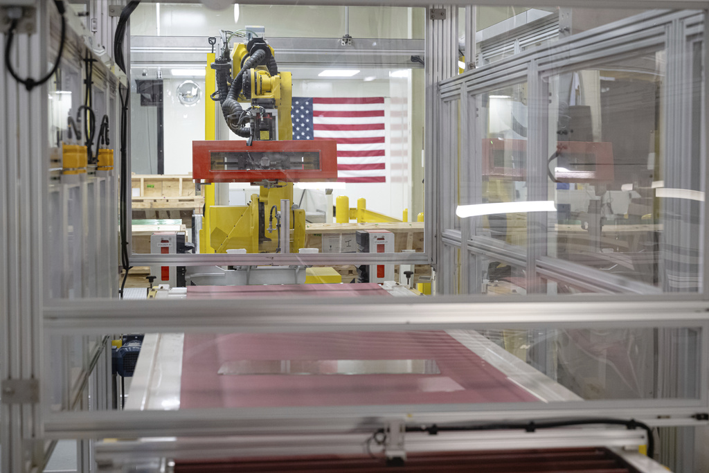 Lengths of glass move down a quality control line during a tour of Corning's iPhone glass manufacturing facility Friday, Sept. 12, 2025, in Harrodsburg, Ky. (AP Photo/Jon Cherry)