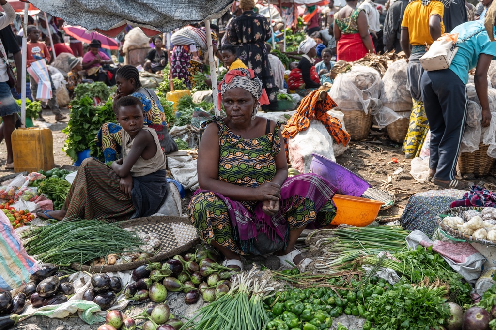 Espérance Mushashine, 44, mother of 12, sells vegetables at the Kituku market on the shores of Lake Kivu in Goma, Democratic Republic of the Congo, Monday, Jan. 26, 2026, a year after M23 took control of the city. (AP Photo/Moses Sawasawa)