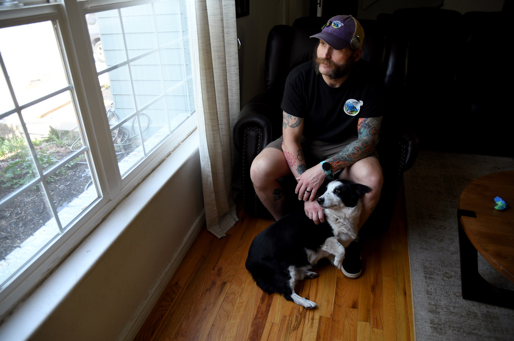 Joe Shearer, who was recently diagnosed with traumatic brain injuries from fighting in Iraq, poses for a portrait in his home in Colorado Springs, Colo., Wednesday, Aug. 5, 2026. (AP Photo/Thomas Peipert)