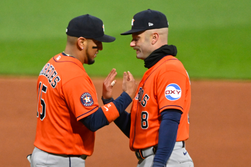 Houston Astros' Isaac Paredes, left, and Christian Walker, right, celebrate a win over the Cleveland Guardians in a baseball game in Cleveland, Monday, April 20, 2026. (AP Photo/David Richard)