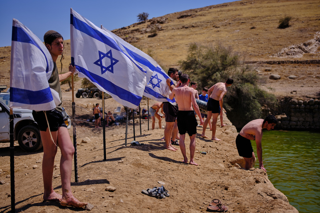 Israelis enjoy a day at an ancient archaeological site known as Herod's Pool, near the Israeli settlement of Petzael, which was filled with water earmarked for Palestinian farmland, in the occupied West Bank's Jordan Valley, on June 19, 2026. (AP Photo/Ohad Zwigenberg)