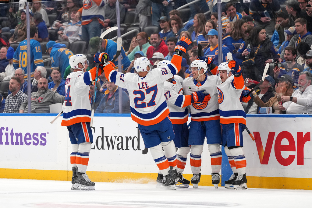 New York Islanders' Mathew Barzal, second from right, celebrates after scoring during overtime of an NHL hockey game to defeat the St. Louis Blues Tuesday, March 10, 2026, in St. Louis. (AP Photo/Jeff Roberson)