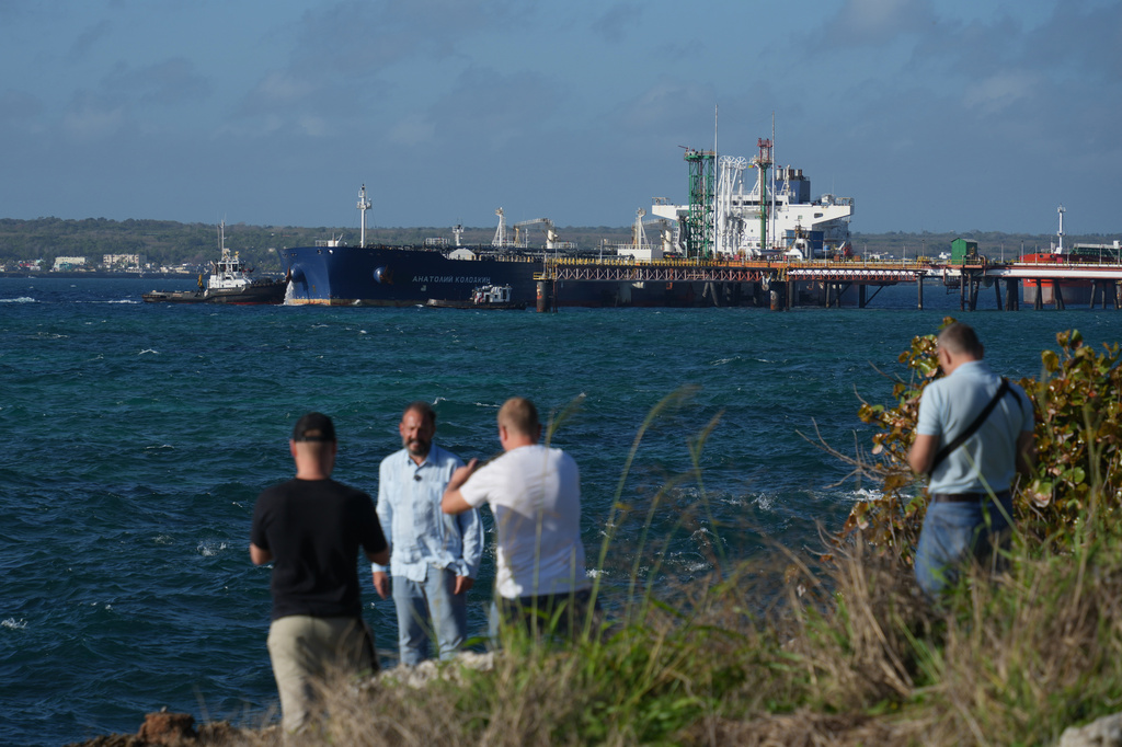Journalists do a standup in front of the Russian-flagged oil tanker Anatoly Kolodkin docked in Matanzas, Cuba, Tuesday, March 31, 2026. (AP Photo/Ramon Espinosa)