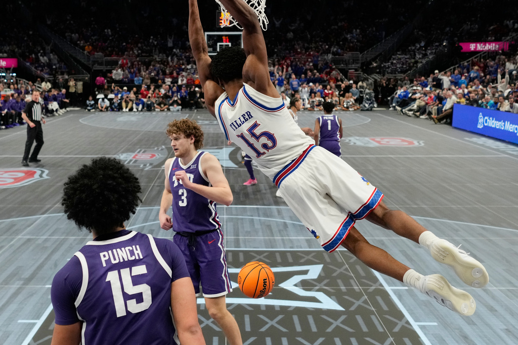 Kansas forward Bryson Tiller (15) dunks the ball during the second half of an NCAA college basketball against TCU game in the quarterfinal round of the Big 12 Conference tournament Thursday, March 12, 2026, in Kansas City, Mo. (AP Photo/Charlie Riedel)
