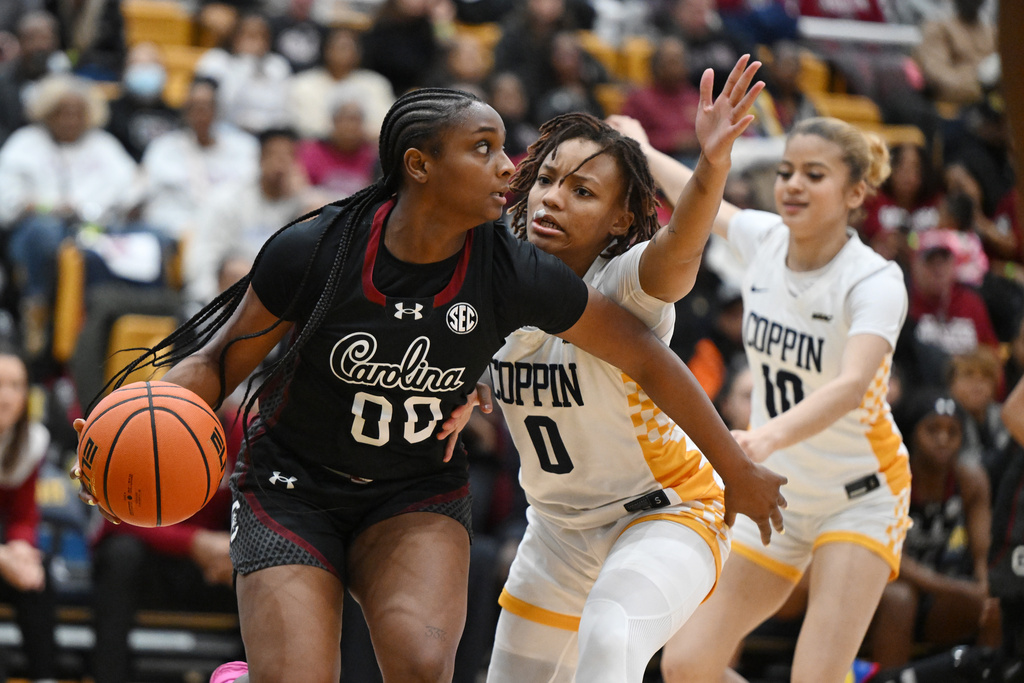 South Carolina guard Ta'niya Latson (00) looks to pass the ball as Coppin State guard Paris McBride (0) pressures during the second half of an NCAA college basketball game Sunday, Jan. 18, 2026, in Baltimore. (AP Photo/Gail Burton)