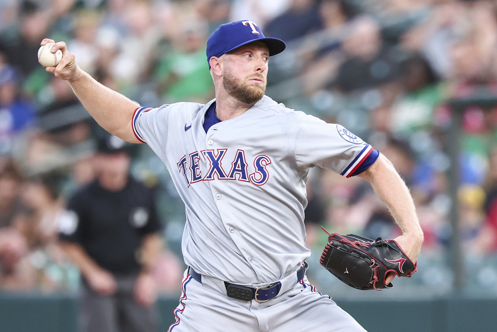 Texas Rangers pitcher Merrill Kelly throws to the Athletics during the first inning of a baseball game Saturday, Aug. 30, 2025, in West Sacramento, Calif. (AP Photo/Sara Nevis)
