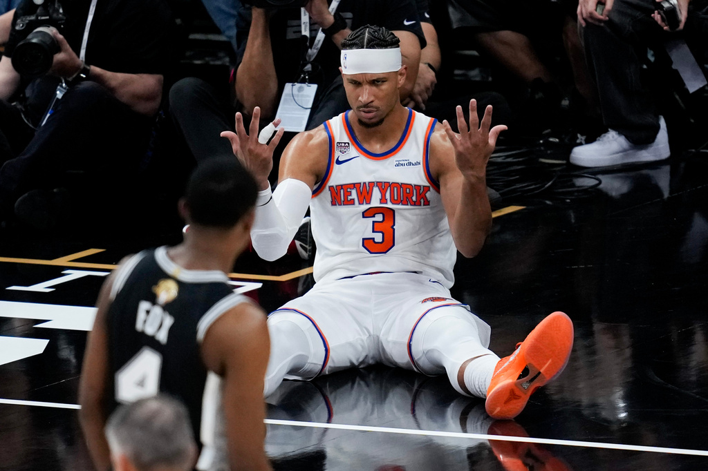 New York Knicks guard Josh Hart (3) looks towards San Antonio Spurs guard De'aaron Fox (4) after a foul during the second half of Game 1 of the NBA Finals basketball series, Wednesday, June 3, 2026, in San Antonio. (AP Photo/David J. Phillip)