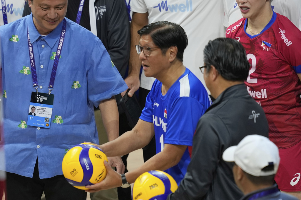 FILE - Philippine President Ferdinand Marcos Jr. center, tosses the ceremonial ball during the opening of the 2025 FIVB Volleyball Men's World Championship in Pasay, Philippines on Friday, Sept. 12, 2025. (AP Photo/Aaron Favila, File)