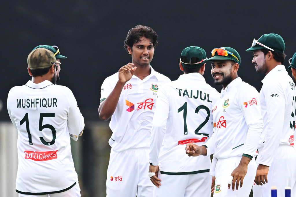 Bangladesh's Hasan Mahmud, second left, celebrates with teammates after taking the wicket of Australia's Travis Head during their cricket test match in Darwin, Australia, Thursday, Aug. 13, 2026. (James Ross/AAP Image via AP)