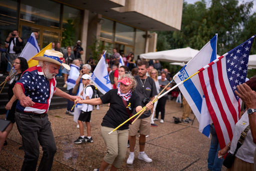 People dance as they celebrate following the announcement that Israel and Hamas have agreed to the first phase of a peace plan to pause the fighting, at a plaza known as hostages square in Tel Aviv, Israel, Thursday, Oct. 9, 2025. (AP Photo/Emilio Morenatti) People dance as they celebrate following the announcement that Israel and Hamas have agreed to the first phase of a peace plan to pause the fighting, at a plaza known as hostages square in Tel Aviv, Israel, Thursday, Oct. 9, 2025. (AP Photo/Emilio Morenatti)