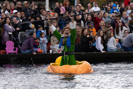 Gary Kristensen, dressed up as the character Buddy from the holiday movie "Elf," celebrates after winning a race during the West Coast Giant Pumpkin Regatta on Sunday, Oct. 19, 2025, in Tualatin, Ore. (AP Photo/Jenny Kane) Gary Kristensen, dressed up as the character Buddy from the holiday movie "Elf," celebrates after winning a race during the West Coast Giant Pumpkin Regatta on Sunday, Oct. 19, 2025, in Tualatin, Ore. (AP Photo/Jenny Kane)