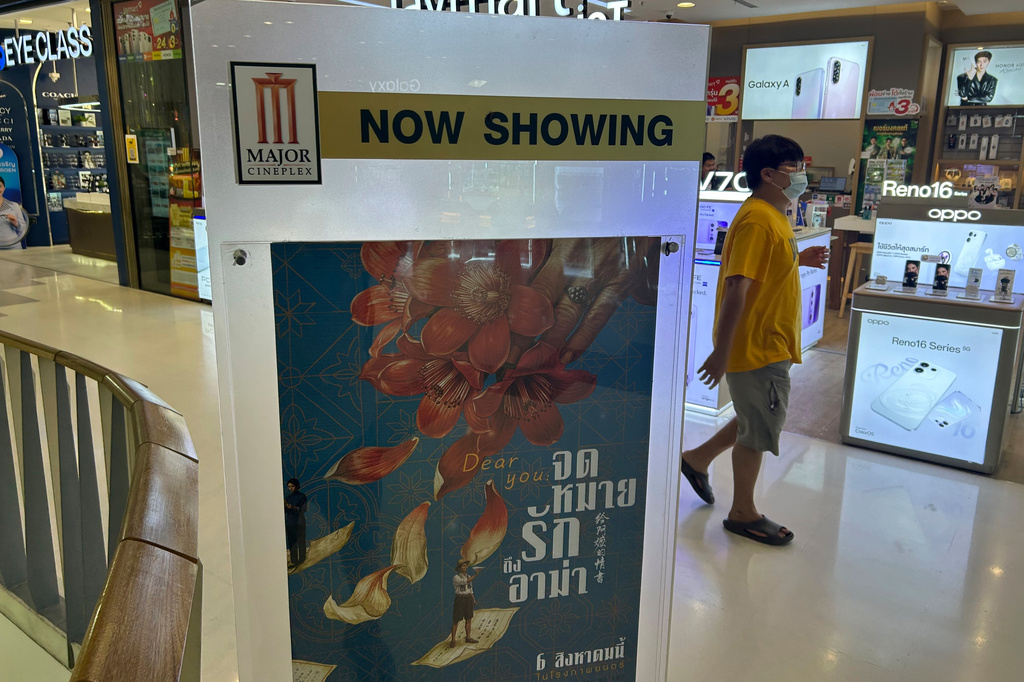 A man walks past a poster for the movie "Dear You" at a shopping mall in Rayong, Thailand, on Aug. 10, 2026. (AP Photo/Sakchai Lalit)