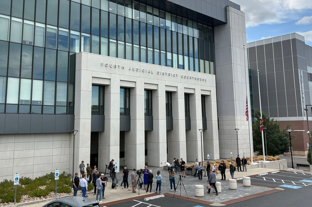 In this photo taken with a smartphone, people gather outside the Fourth Judicial District Courthouse in Provo, Utah, before a key hearing for Tyler Robinson, who is accused in the fatal shooting of Charlie Kirk, Tuesday, Sept. 1, 2026. (AP Photo/Hannah Schoenbaum)
