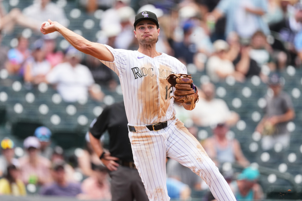 Colorado Rockies third baseman Kyle Karros throws out Washington Nationals' Luis García Jr. at first base to end the top of the fifth inning of a baseball game Wednesday, July 22, 2026, in Denver. (AP Photo/David Zalubowski)