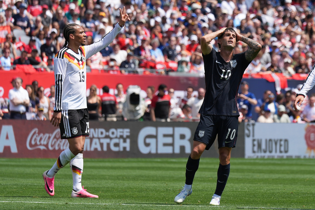 United States forward Christian Pulisic, right, reacts after a missed a shot as Germany forward Leroy Sané celebrates during the first half of an international friendly soccer match in Chicago, Saturday, June 6, 2026. (AP Photo/Nam Y. Huh)