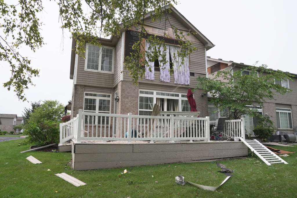 A home is damaged after a storm in Tinley Park, Ill., Tuesday, Aug. 11, 2026. (AP Photo/Laura Bargfeld)