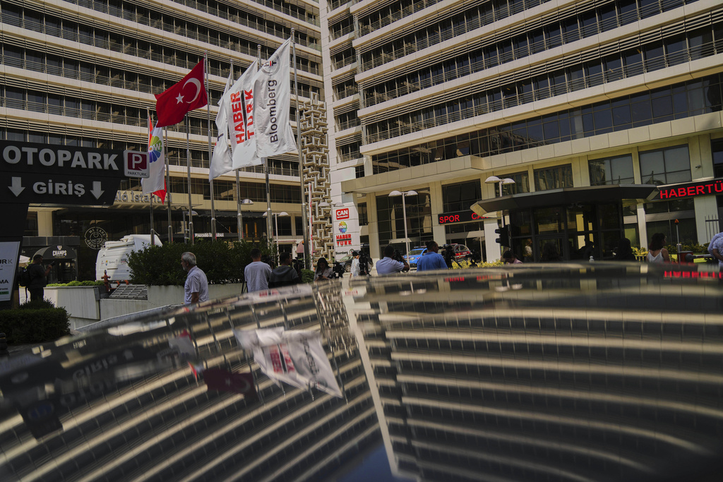 Journalists work outside Haberturk and ShowTv news broadcasters offices, both part of Turkish Can Holding media group, in Istanbul, Turkey, Thursday, Sept. 11, 2025. (AP Photo/Francisco Seco)
