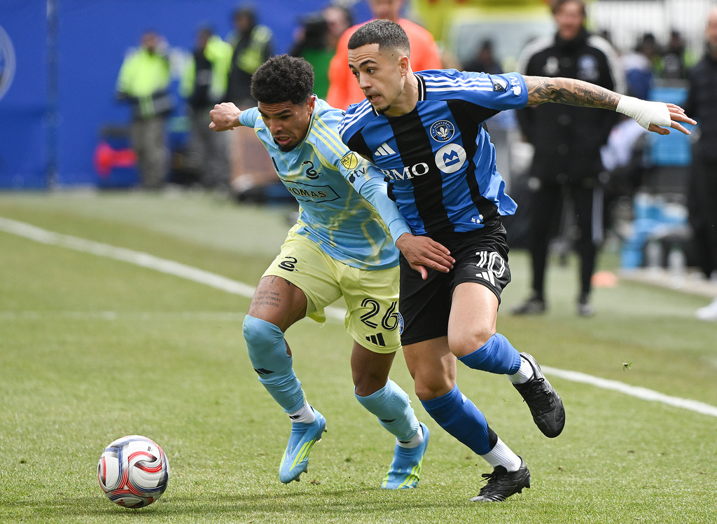 CF Montreal's Ivan Jaime (10) tries to get by Philadelphia Union's Nathan Harriel (26) during the first half of an MLS soccer match in Montreal, Saturday, April 11, 2026. (Graham Hughes/The Canadian Press via AP)
