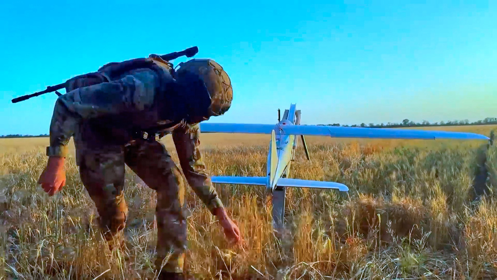 In this image made from video provided by Russian Defense Ministry Press Service on Wednesday, May 27, 2026, a Russian serviceman launches a drone for an action in an undisclosed location in Ukraine. (Russian Defense Ministry Press Service via AP)