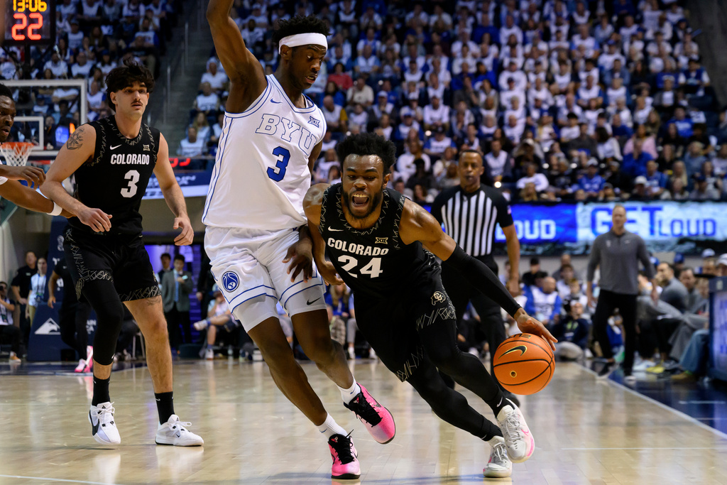 Colorado guard Barrington Hargress (24) drives to the basket guarded by BYU forward AJ Dybantsa (3) during the second half of an NCAA college basketball game, Saturday, Feb. 14, 2026, in Provo, Utah. (AP Photo/Tyler Tate)