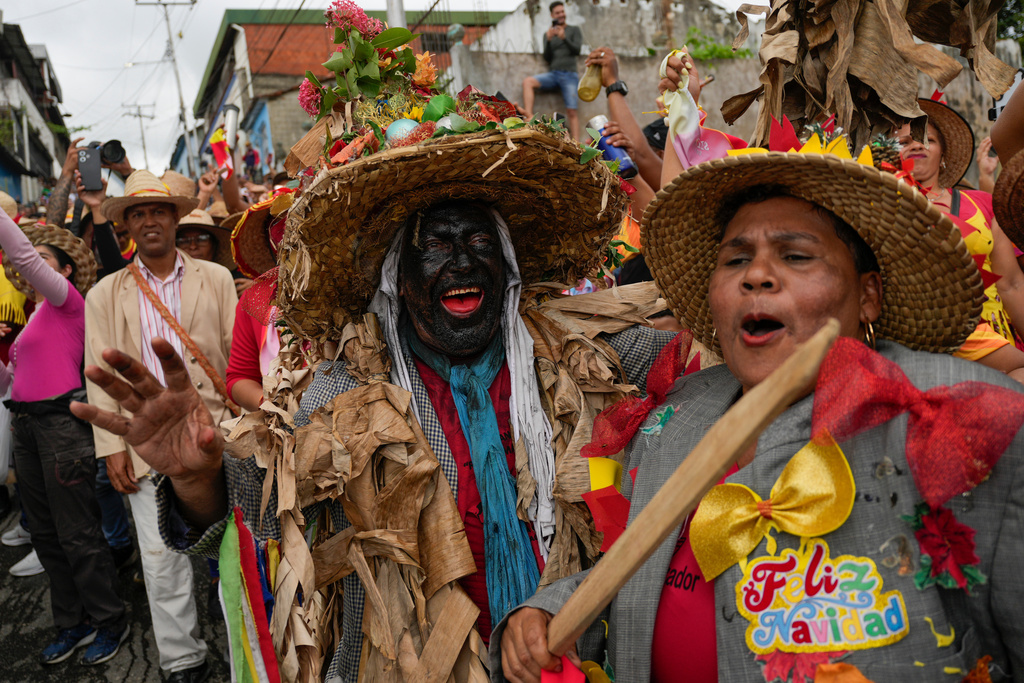 Revelers take part in the Afro-Venezuelan Holy Innocents' Day celebration in Caucagua, Venezuela, Sunday, Dec. 28, 2025. (AP Photo/Matias Delacroix)