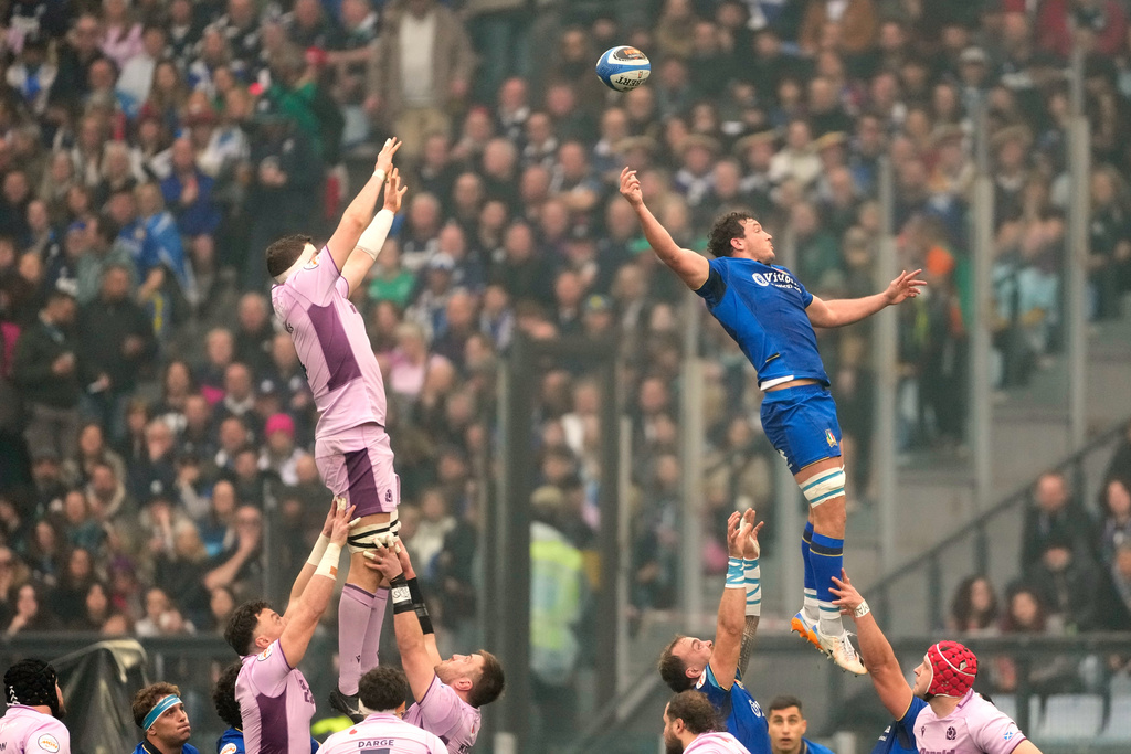 Italy's Michele Lamaro, right, and Scotland's Scott Cummings go airborn during the Six Nations rugby match between Italy and Scotland at Rome's Olympic Stadium, Saturday, Feb. 7, 2026. (AP Photo/Gregorio Borgia)