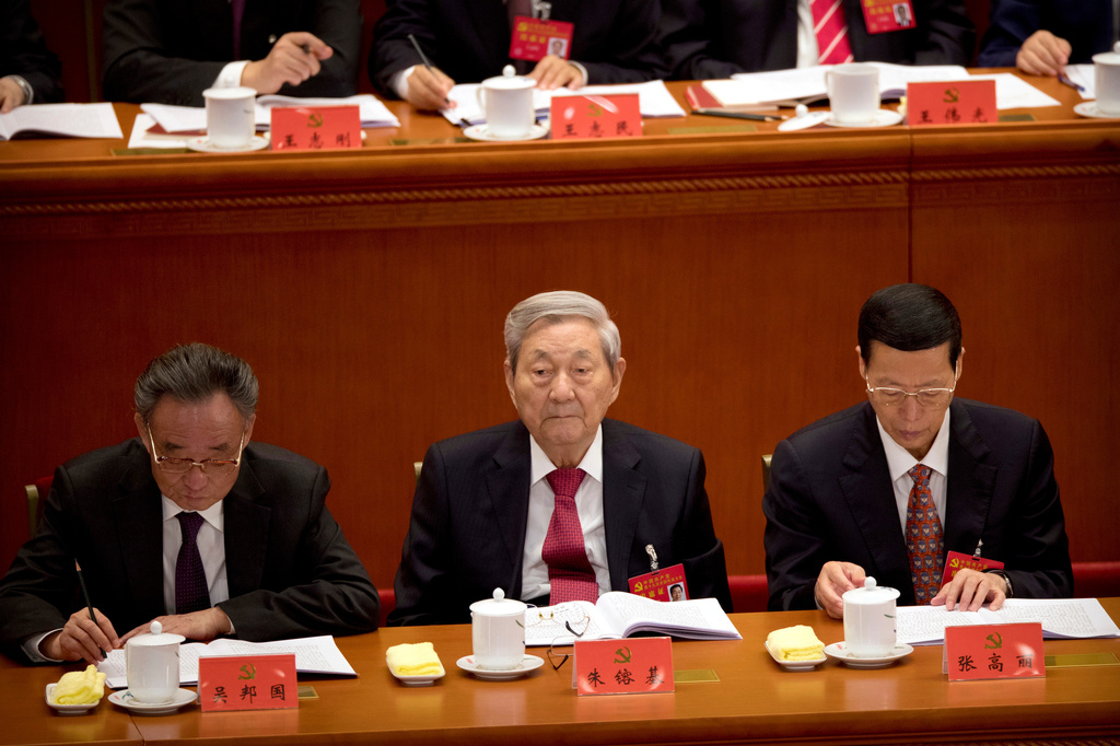 FILE - Former Chinese Premier Zhu Rongji, center, listens to a speech by Chinese President Xi Jinping during the opening session of China's 19th Party Congress at the Great Hall of the People in Beijing, Wednesday, Oct. 18, 2017. (AP Photo/Mark Schiefelbein, File)