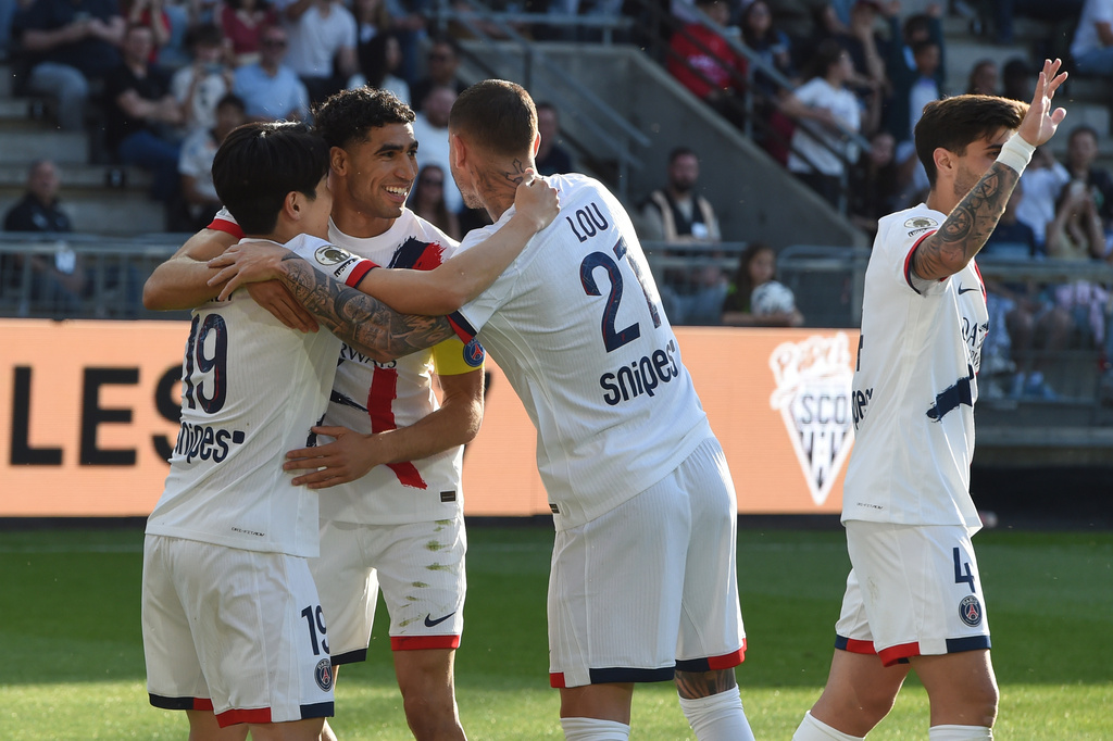 PSG's Lee Kang-in, left, celebrates with Achraf Hakimi and Lucas Hernandez after scoring during the French League One soccer match between Angers and Paris Saint-Germain in Angers, western France, Saturday, April 25, 2026. (AP Photo/Mathieu Pattier)