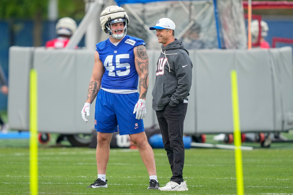 New York Giants head coach John Harbaugh, right, talks with New York Giants fullback Grant Finley, left, (45) at rookie minicamp at the NFL football team's practice facility, Saturday, May 9, 2026, in East Rutherford, N.J. (AP Photo/Yuki Iwamura)