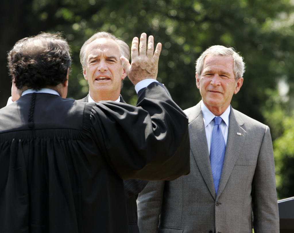 FILE - New Interior Secretary Dirk Kempthorne, left, is sworn in by Supreme Court Justice Anthony Scalia, in black robe, with President Bush at his side on the South Lawn of the White House in Washington Wednesday, June 7, 2006. (AP Photo/Gerald Herbert, File)