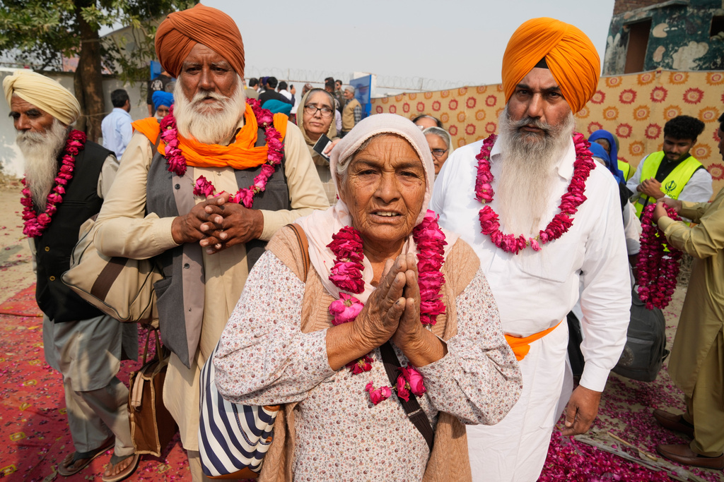 Indian Sikh pilgrims enter Pakistan through the Wagah border crossing point, to participate in celebrations marking the birth anniversary of Guru Nanak, at Gurdwara Janam Asthan Nankana Sahib, near Lahore, Pakistan, Tuesday, Nov. 4, 2025. (AP Photo/K.M. Chaudary)